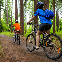 Couple biking riding through nature.