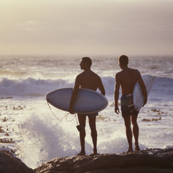 Surfers watching the waves on the beach